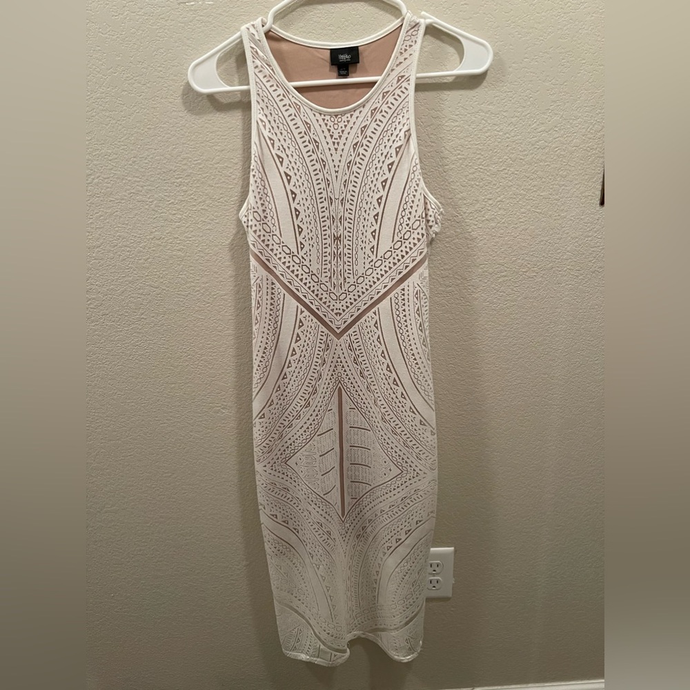 Woman’s cream colored nude dress.